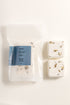 Packaged shower steamers with a blue label on a white background