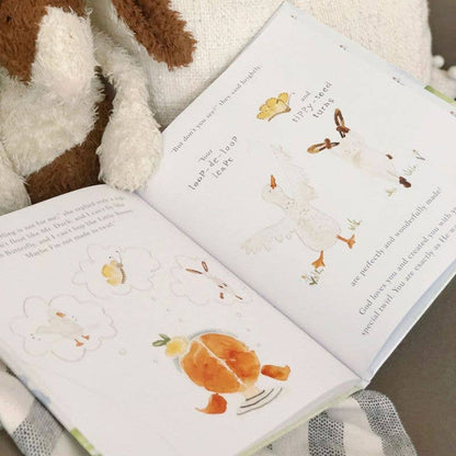 Open book with animal illustrations on a soft surface