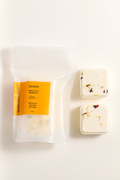 Two shower steamers with packaging on a white background