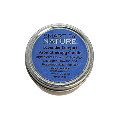 A round silver metal tin candle with a blue label reading &