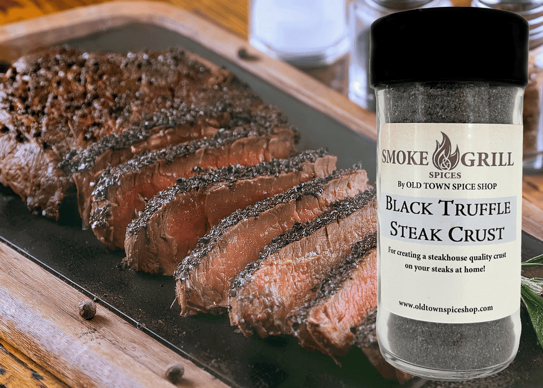 Sliced steak with a jar of Smoke &amp; Grill Spices Black Truffle Steak Crust on a wooden cutting board.