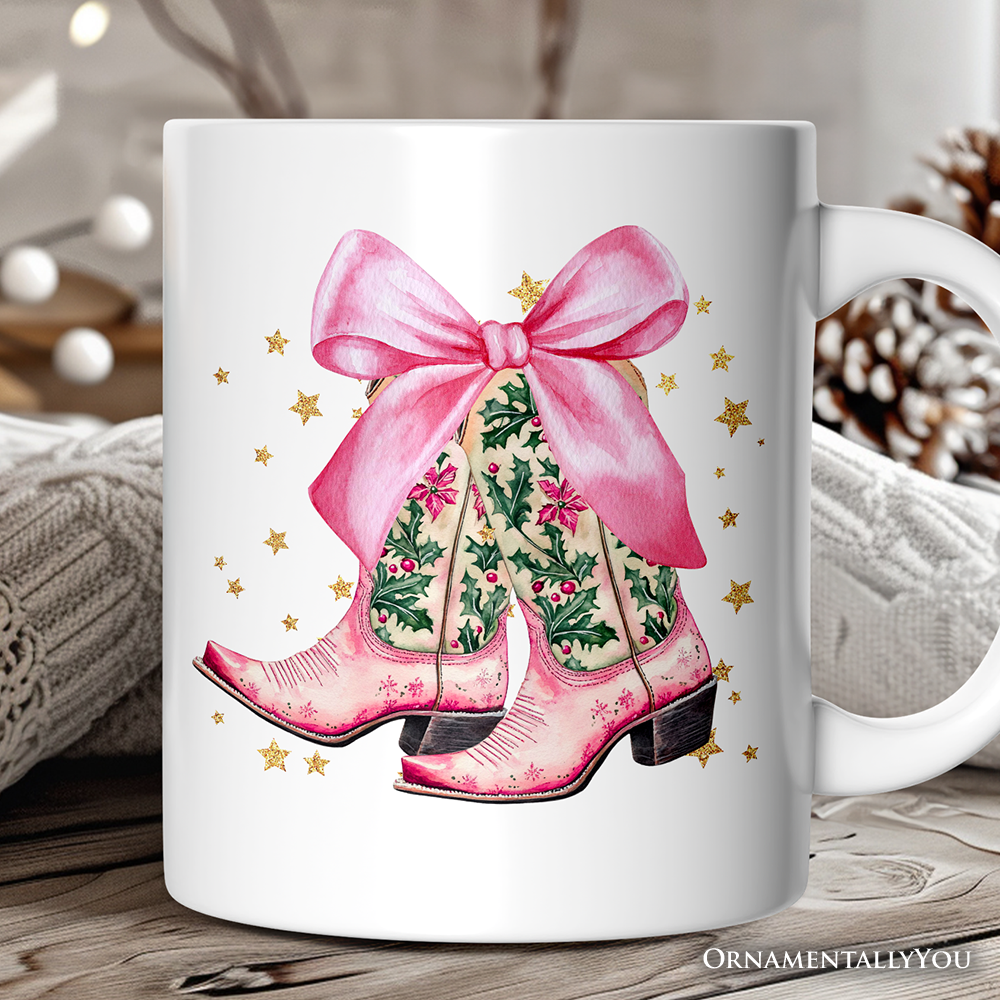 White mug with pink cowboy boots and a bow design on a wooden surface.