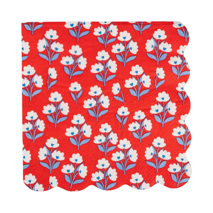 Floral patterned paper napkin with white flowers on a red background