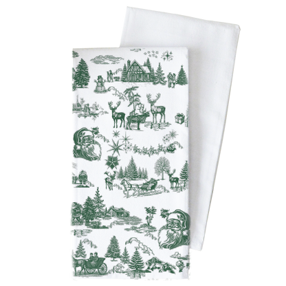 A white fabric tea towel with a green Christmas-themed toile pattern, shown with a second plain white towel behind it on a white background.