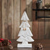 Decorative white Christmas tree with a bow on a wooden surface with pinecones and berries.