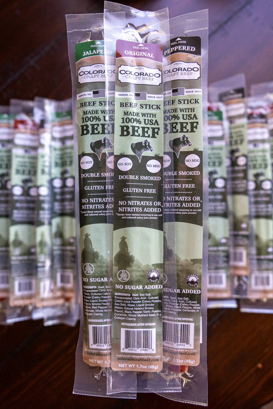 Packaged beef sticks with labels on a blurred background