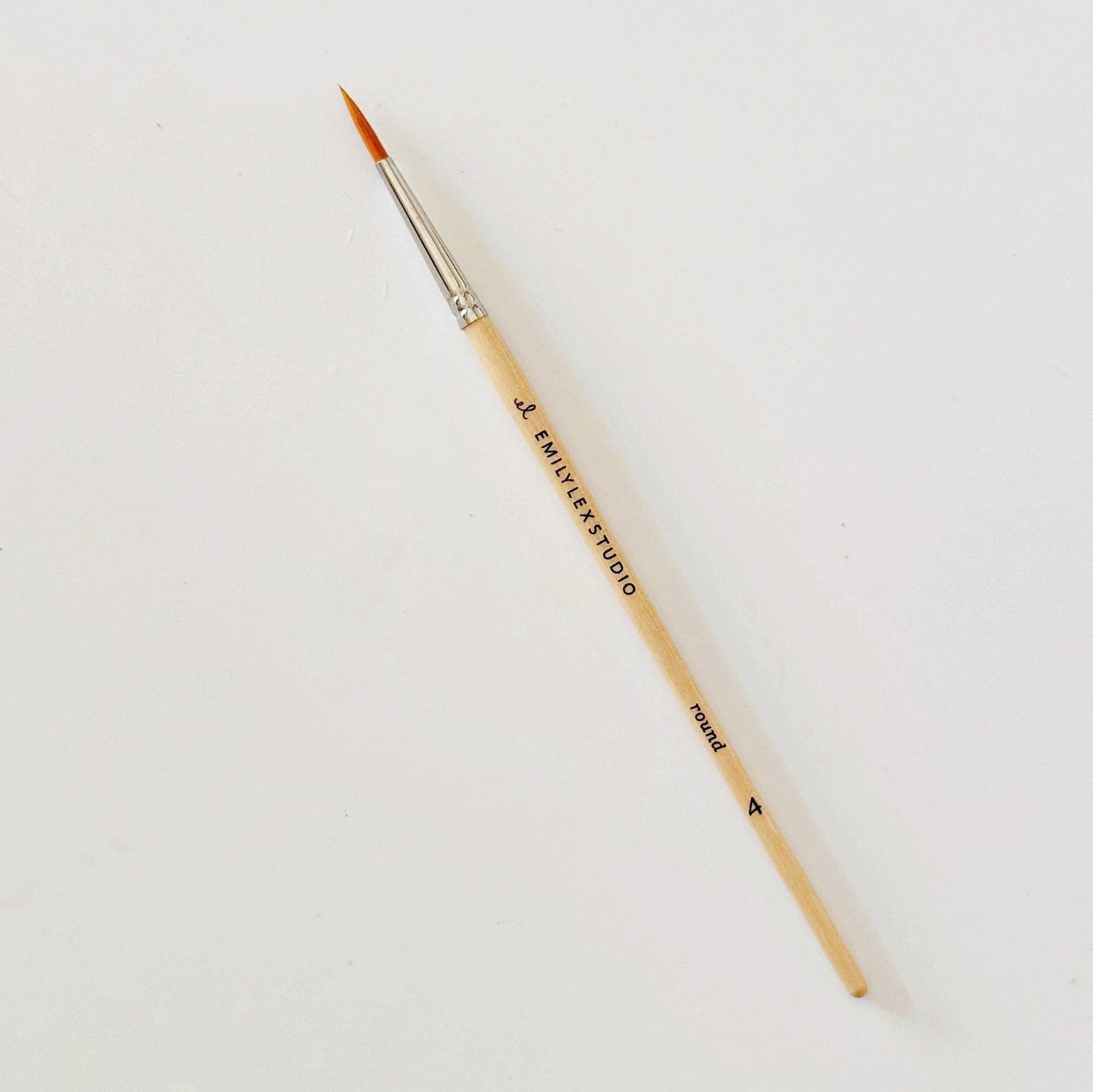 Paintbrush with wooden handle and metal ferrule on a white background