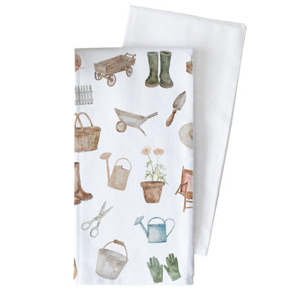 Two folded towels with gardening-themed patterns on a white background