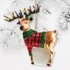 Decorative reindeer ornament with lights and a plaid pattern on a white background