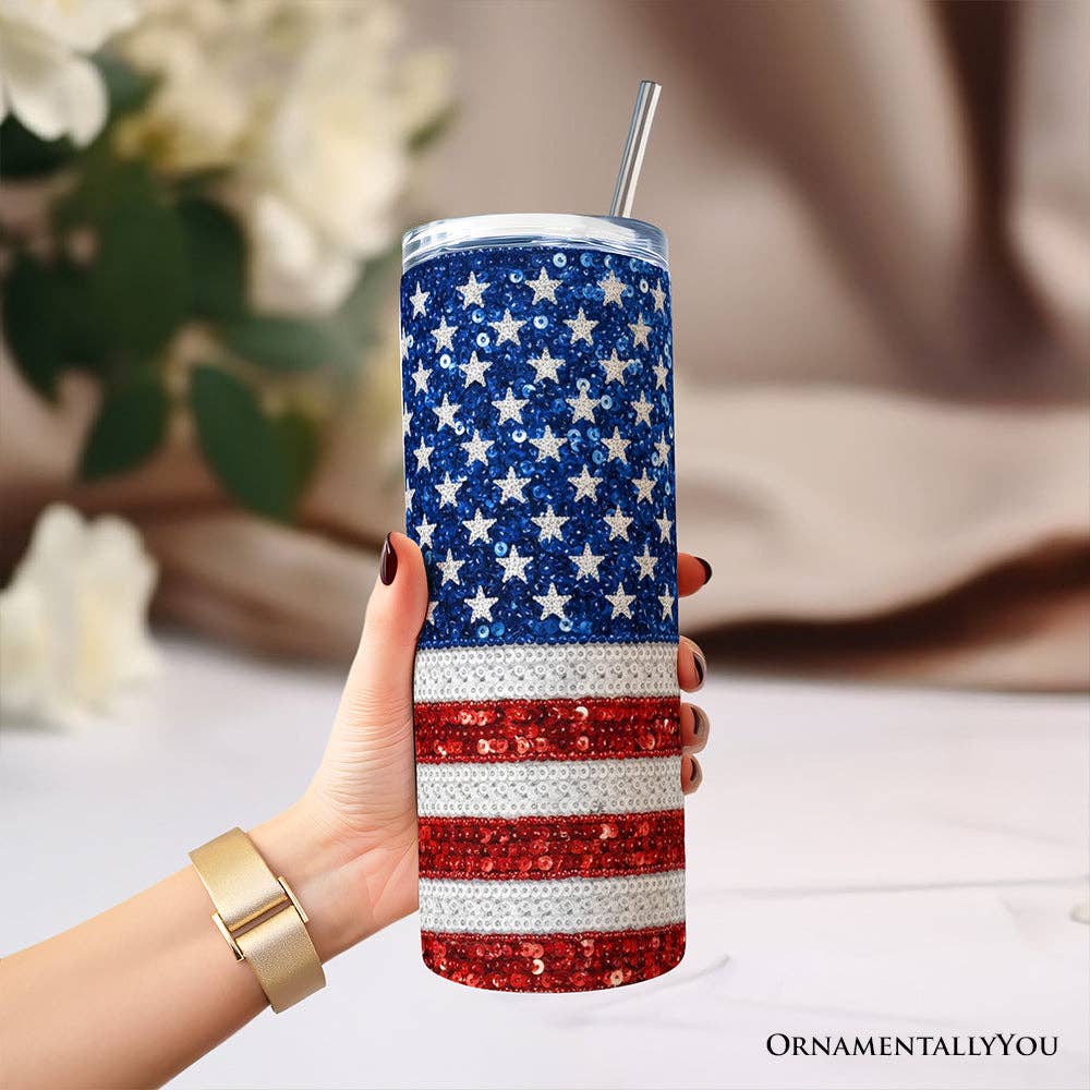 Tumbler with American flag design held by a hand, blurred background