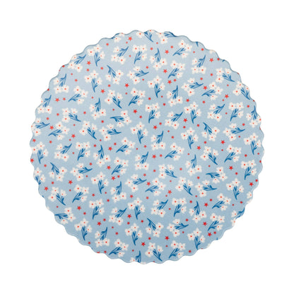 Round bamboo plate with floral pattern on a light blue background