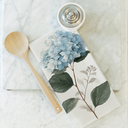 Notebook with floral design on a marble surface with a wooden spoon and small container.