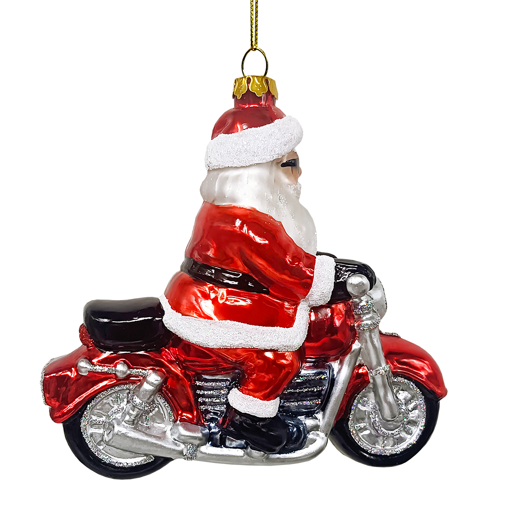 Glass ornament of Santa Claus riding a motorcycle on a white background