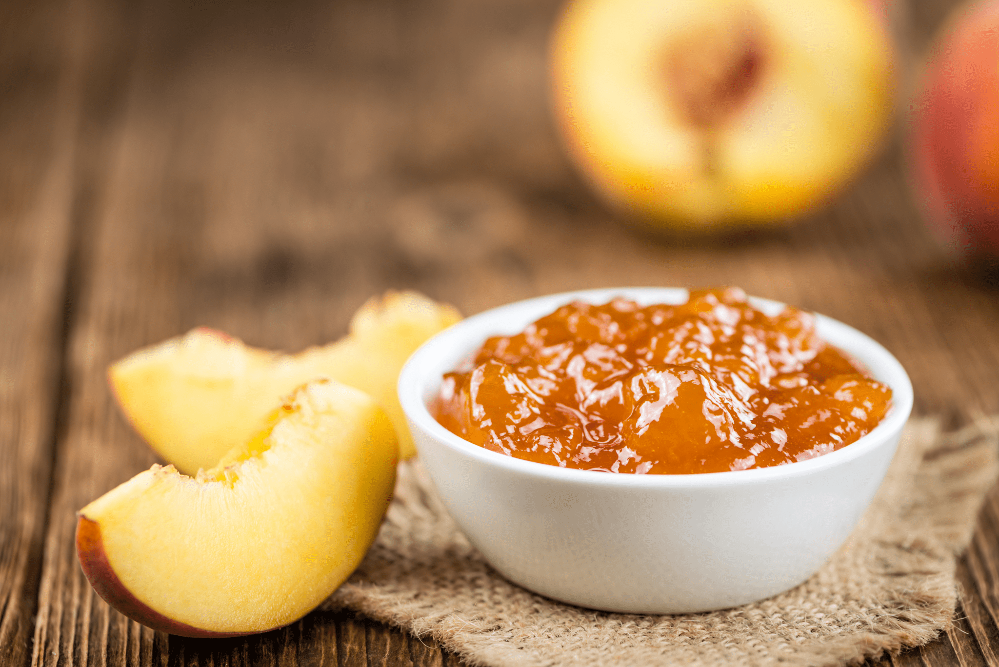 Naked Goat Farm Bourbon Peach Jam in Bowl with Fresh Peaches