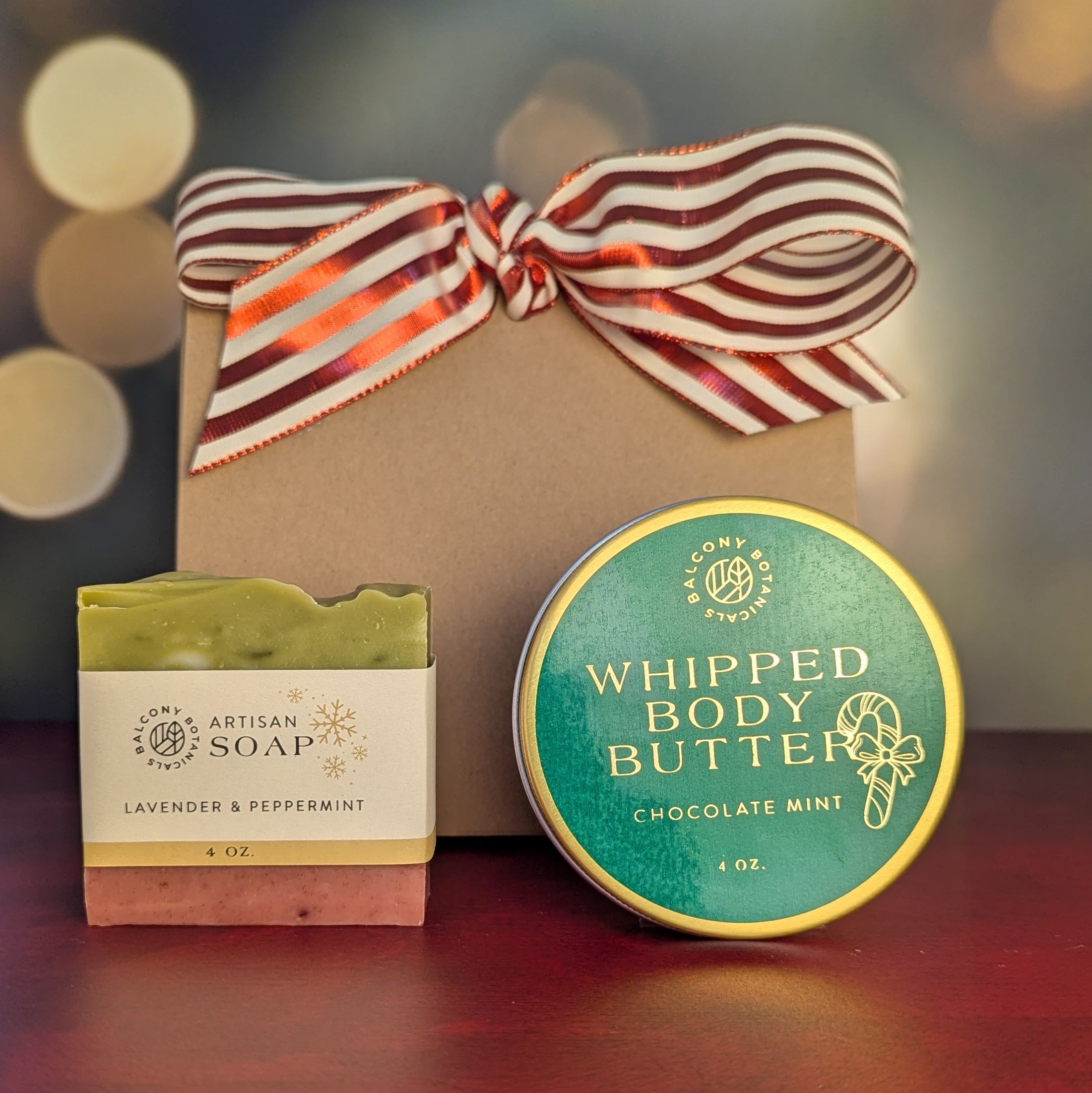 Lavender and peppermint bar soap and chocolate mint whipped body butter gift bundle with red and white bow.