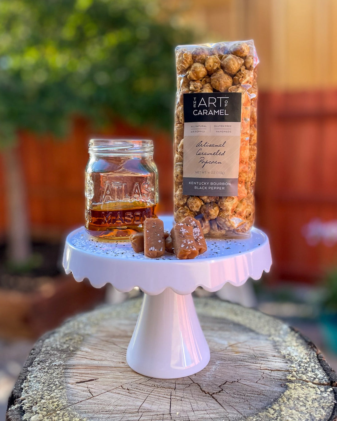 Kentucky Bourbon Black Pepper Caramel Popcorn on Stand with Caramels and Bourbon