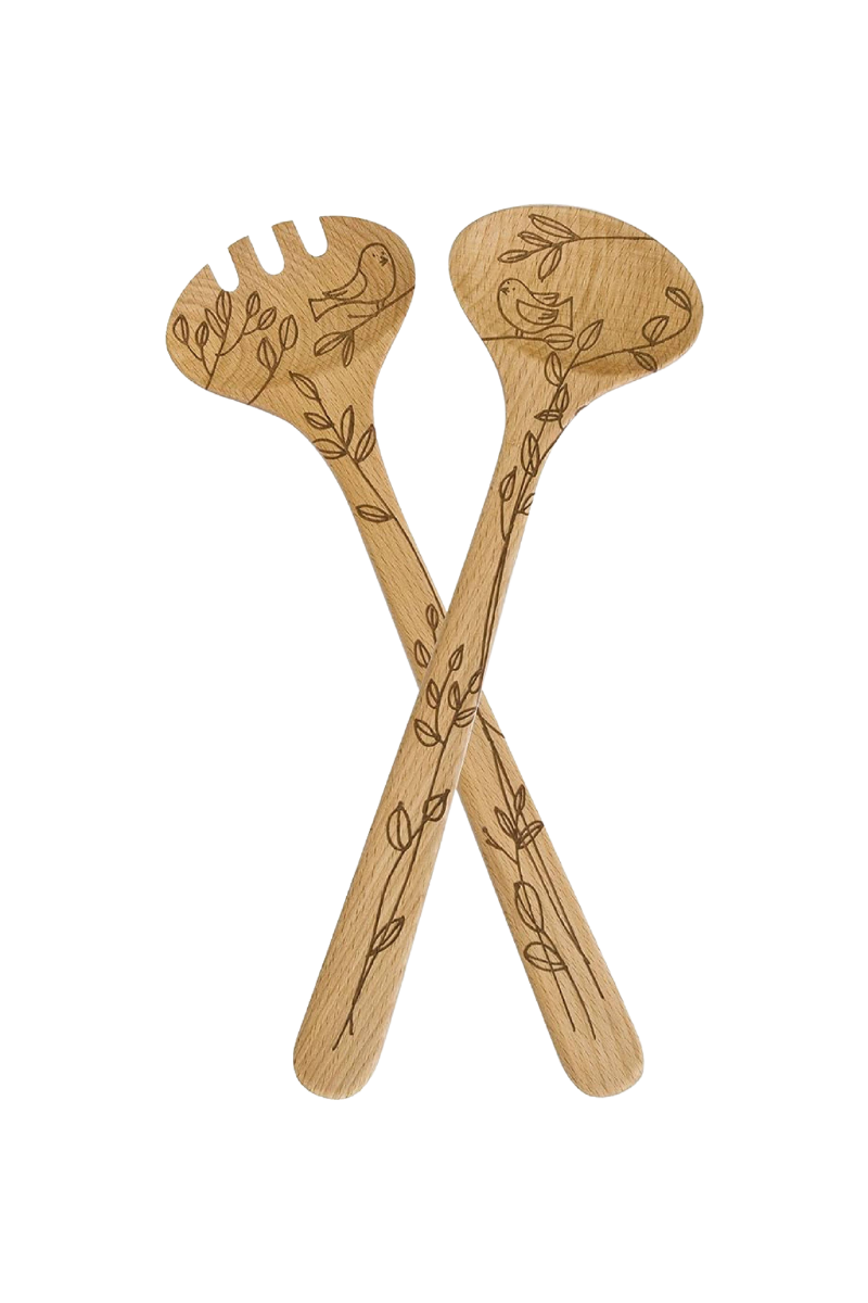 Wooden salad servers with engraved designs on a white background