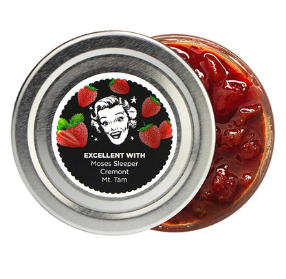 Jar of strawberry jam with a decorative label featuring a vintage-style illustration.