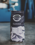 Summit Coffee Roasters coffee bag on a concrete surface with a blurred blue vehicle in the background
