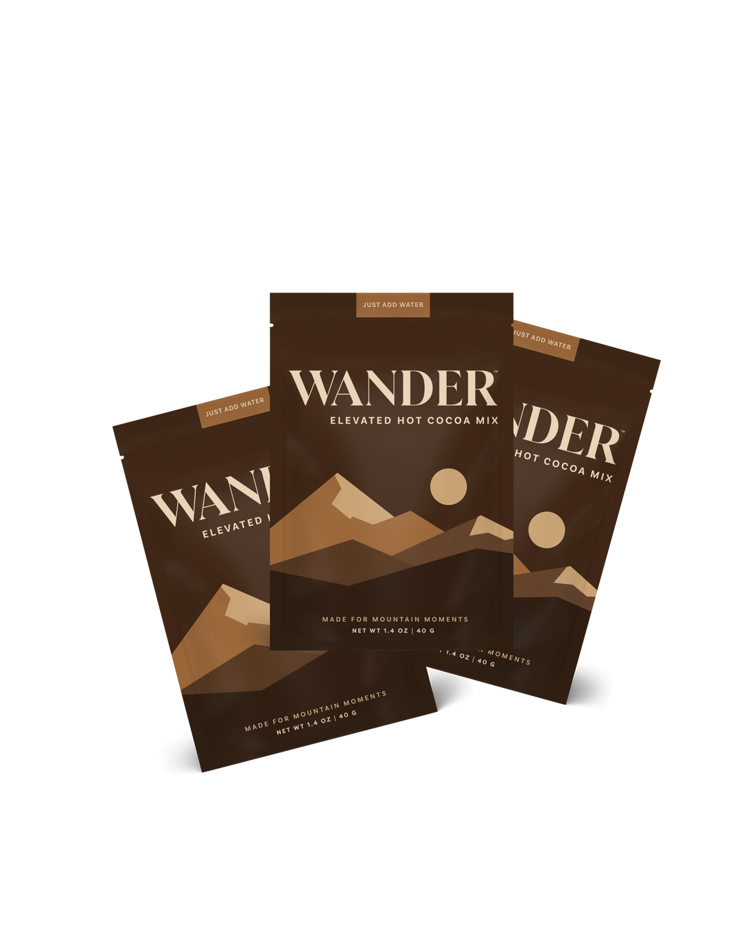 Three packages of Wander Elevated Hot Cocoa Mix on a white background
