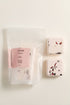 Two square shower steamers with floral designs on a white background, accompanied by a pink packaging labeled &