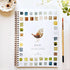 A spiral-bound watercolor workbook titled &