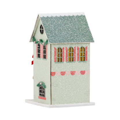 Decorative birdhouse with a snowy roof on a white background
