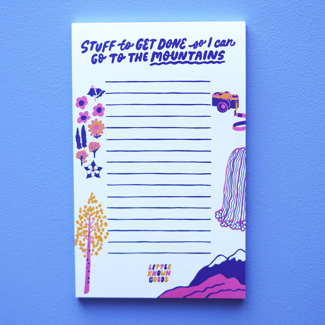 Notepad with mountain-themed design and text on a blue background
