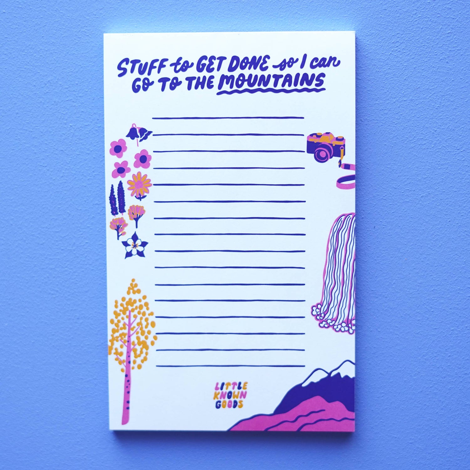 Notepad with mountain-themed design and text on a blue background