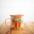 Mug with cowboy boot and floral design on a wooden surface