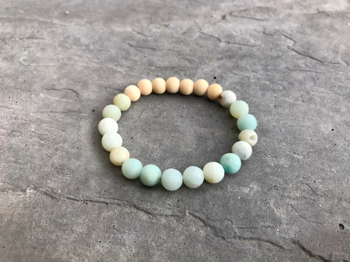 Beaded bracelet with multicolor beads on a gray surface