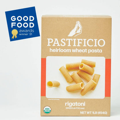 A 1 lb box of Pastificio Heirloom Wheat Pasta Rigatoni on a white background, featuring a blue Good Food Awards 2021 badge in the top left corner.
