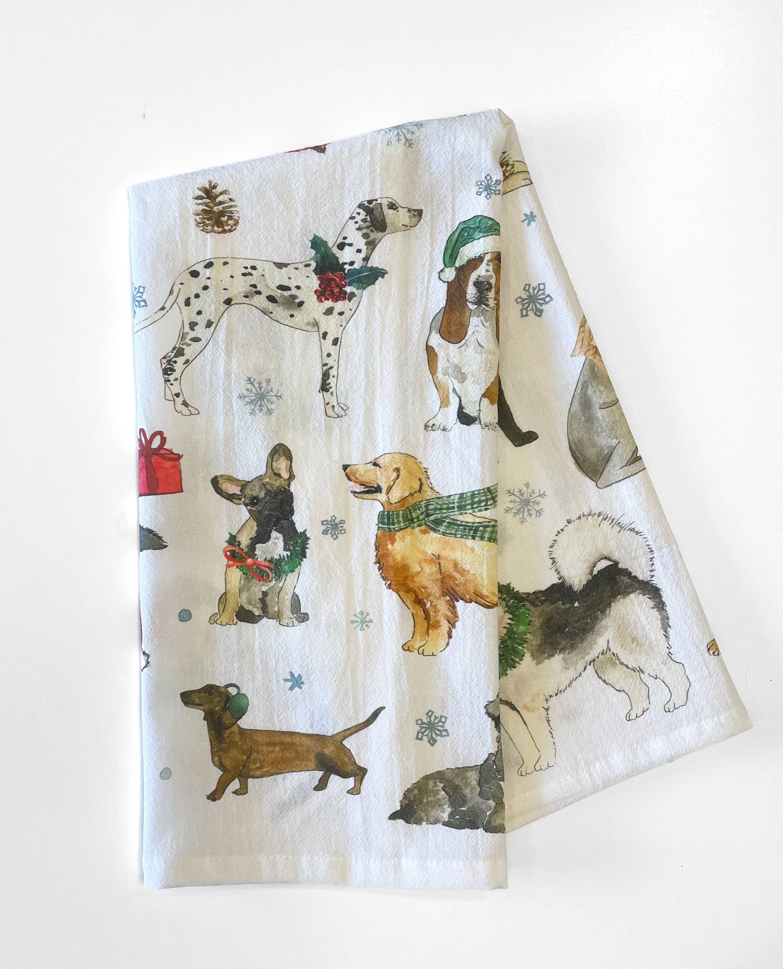 Tea towel with illustrations of dogs wearing Christmas accessories on a white background