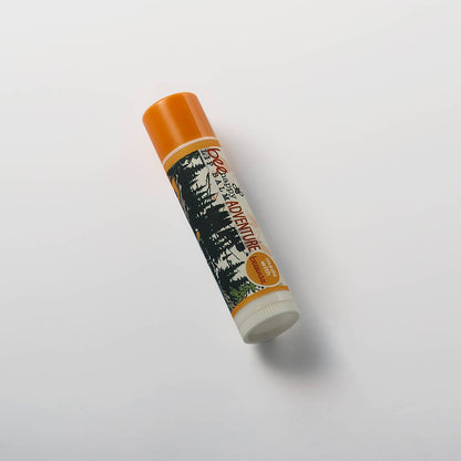 Lip balm with an orange cap and label on a white background