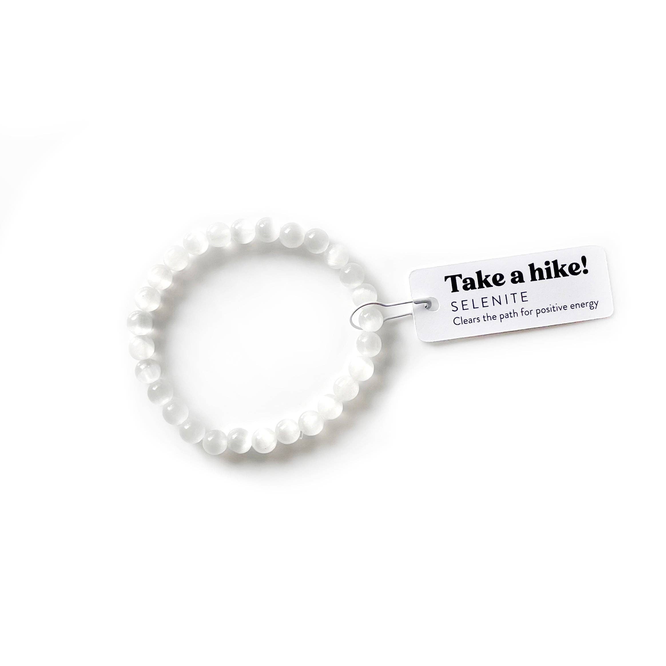 White beaded bracelet with a tag on a white background
