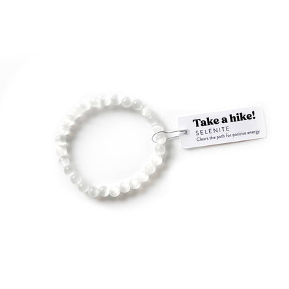 White beaded bracelet with a tag on a white background