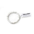 White beaded bracelet with a tag on a white background