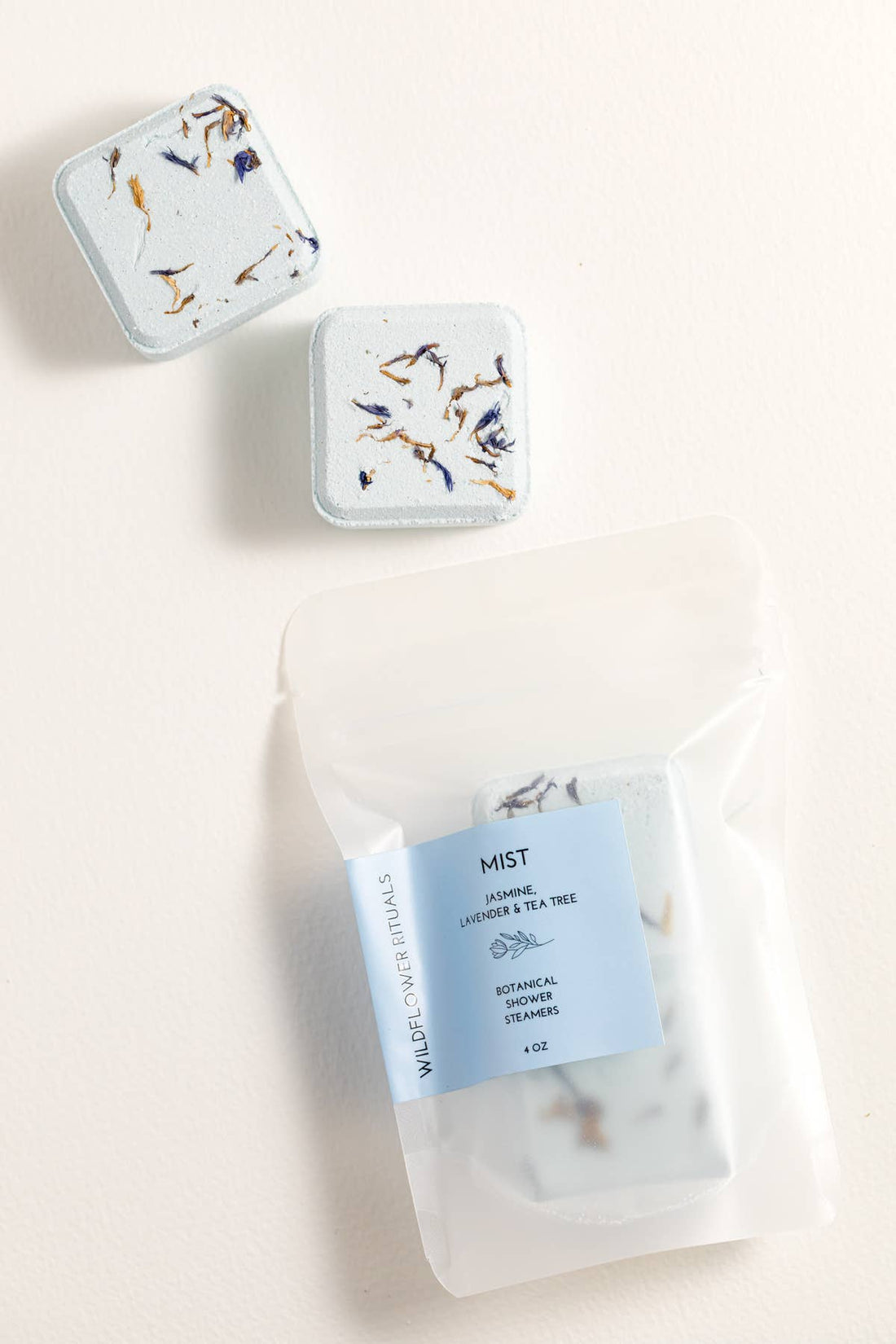 Two small rectangular containers with floral designs on a light background