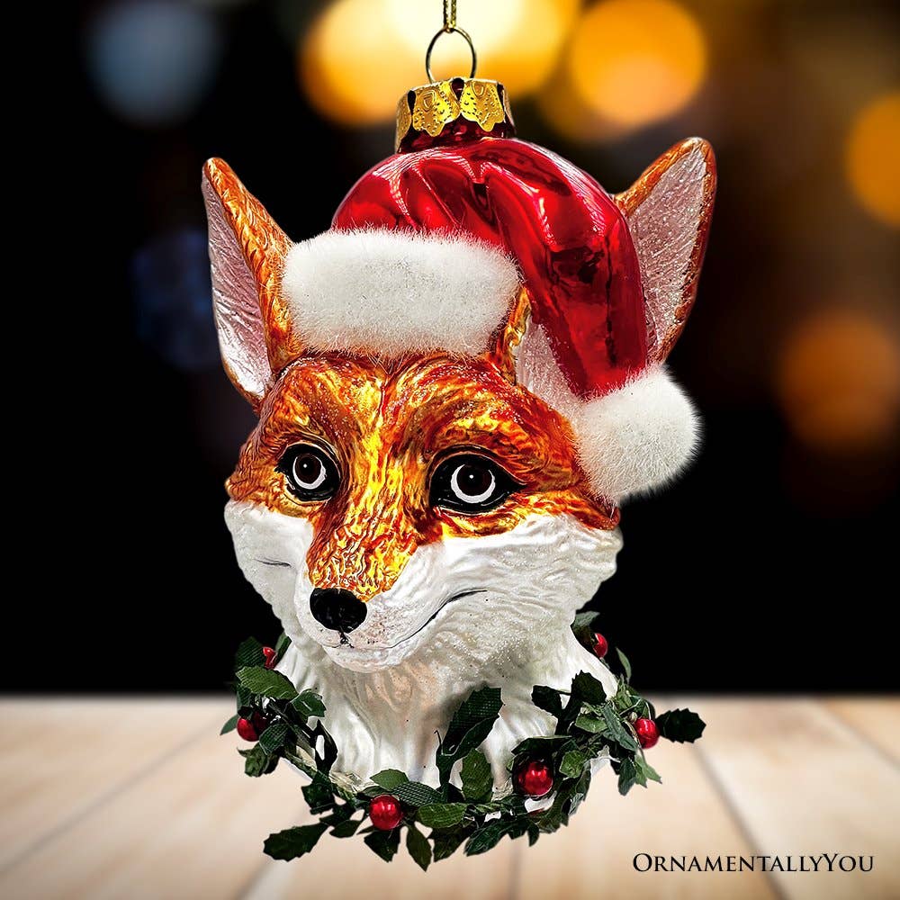 Fox ornament wearing a Santa hat with a blurred background