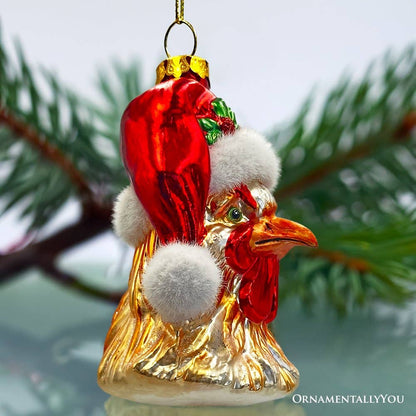 Decorative rooster Christmas ornament with Santa hat on a blurred green background