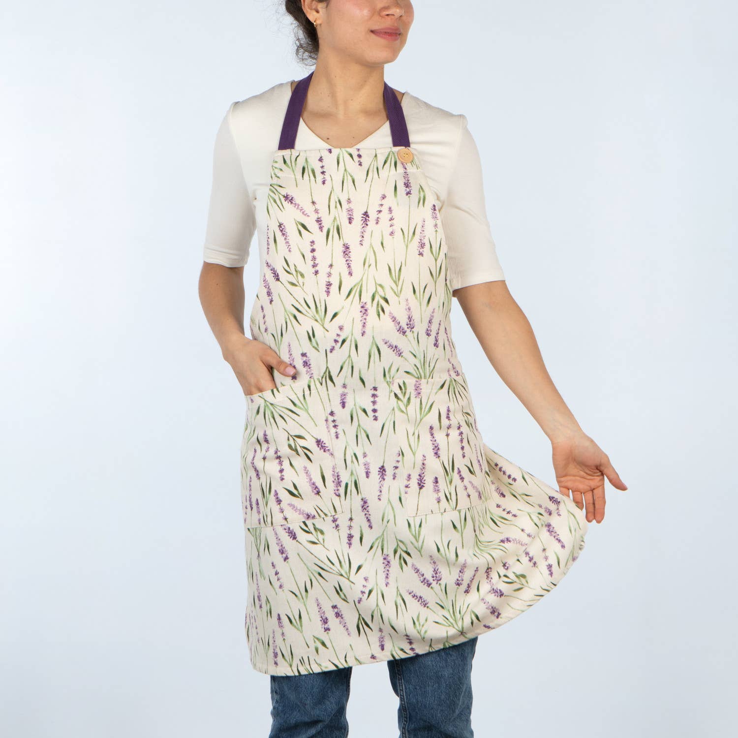 Person wearing a floral apron on a plain background