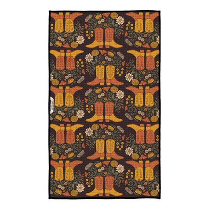 Decorative rug with cowboy boot and floral pattern on a dark background