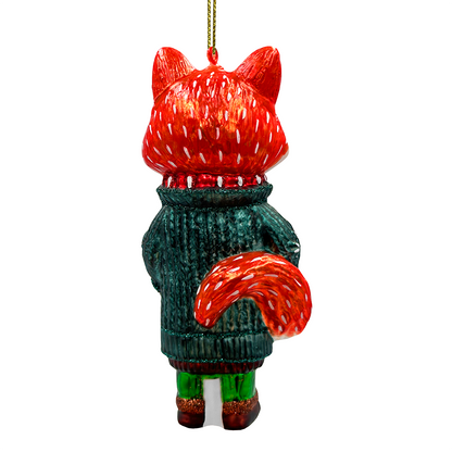 Decorative fox ornament wearing a green sweater on a white background