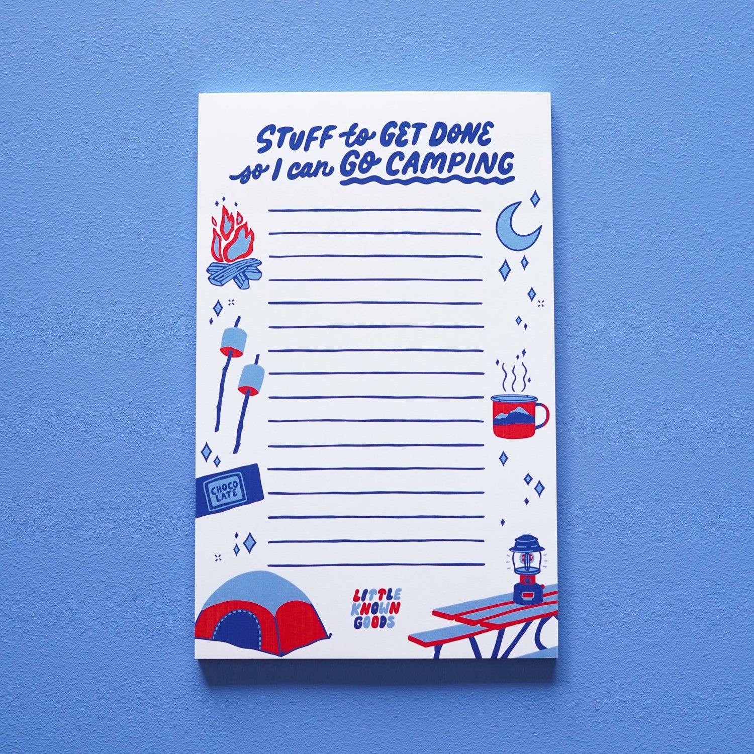 Notepad with camping-themed illustrations and text on a blue background