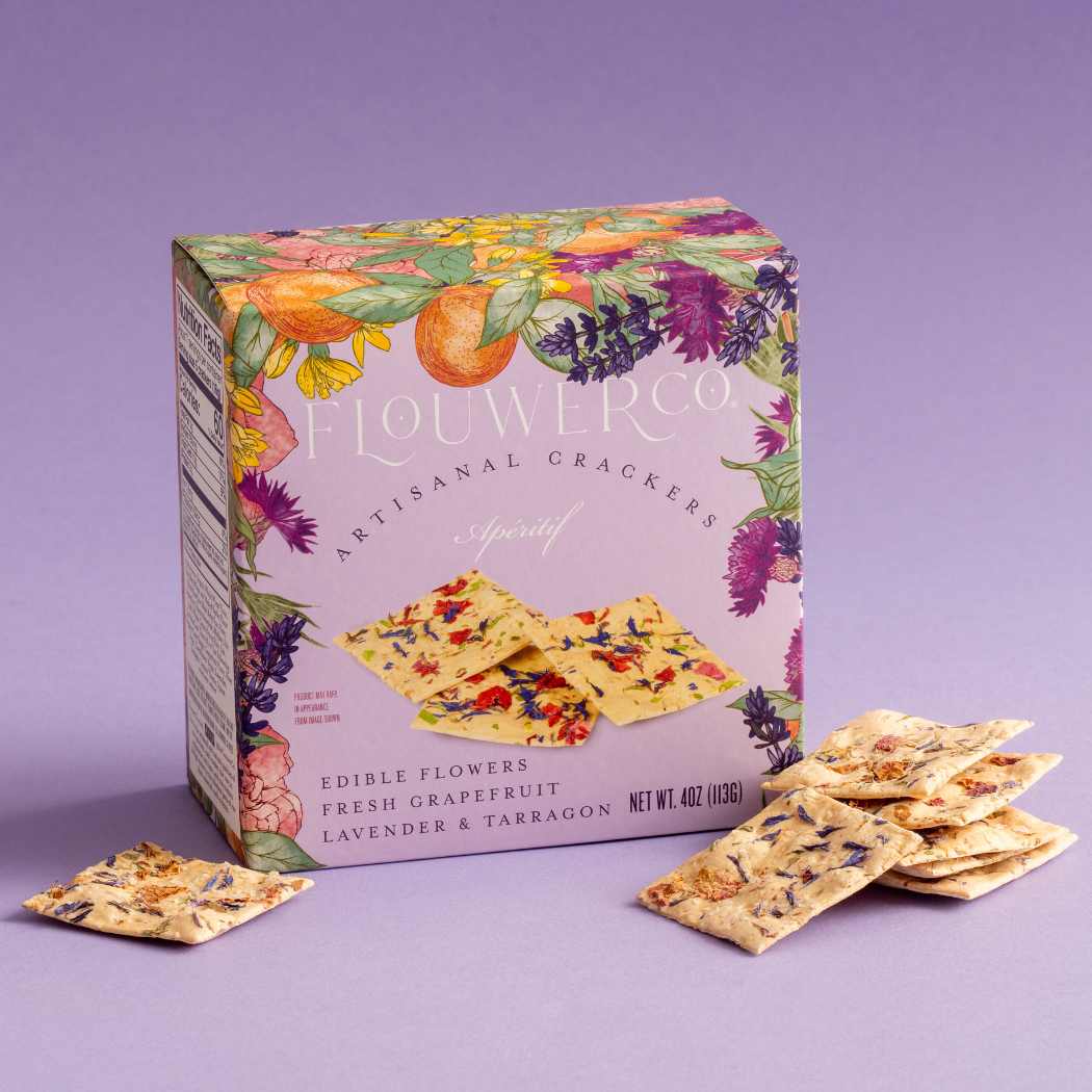 Flourish Co. crackers with a colorful box on a purple background