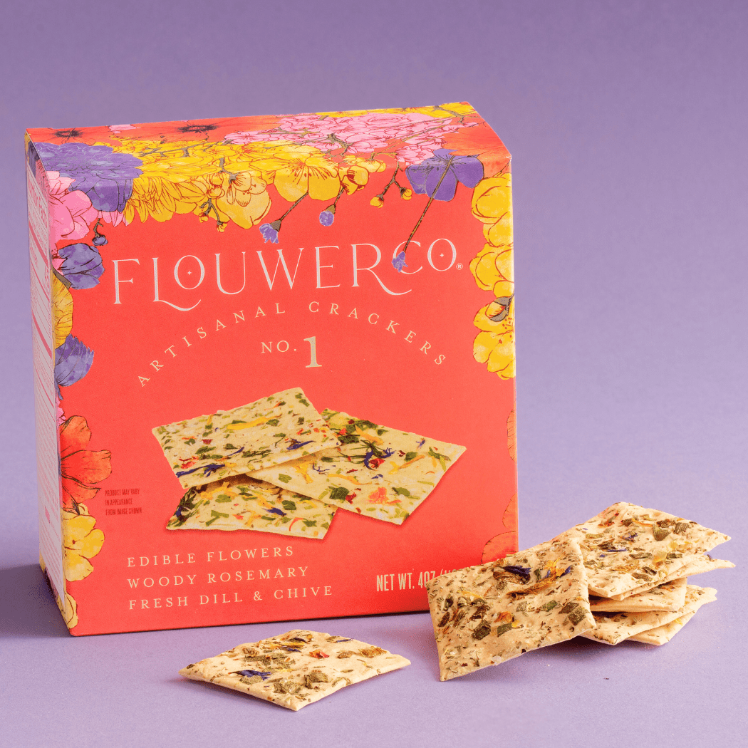 Flower Co artisanal crackers packaging with crackers on a purple background
