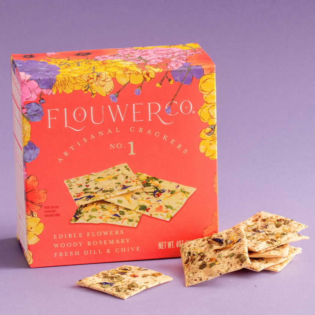 Flower Co artisanal crackers packaging with crackers on a purple background