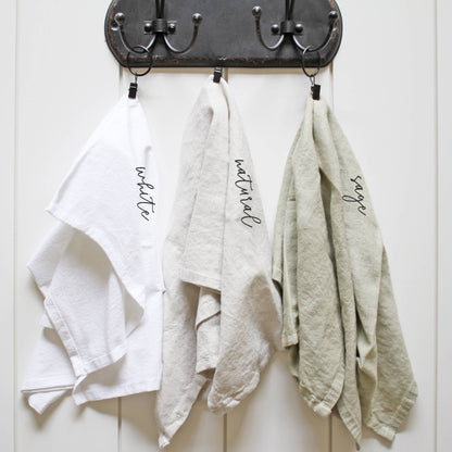 Three dishtowels labeled &