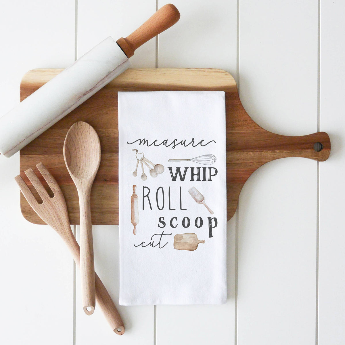 Wooden cutting board with kitchen utensils and a humorous quote on a white background