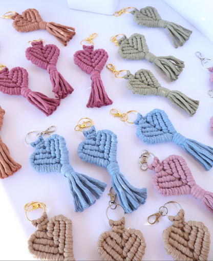 Set of colorful macrame keychains on a white surface with a blurred background